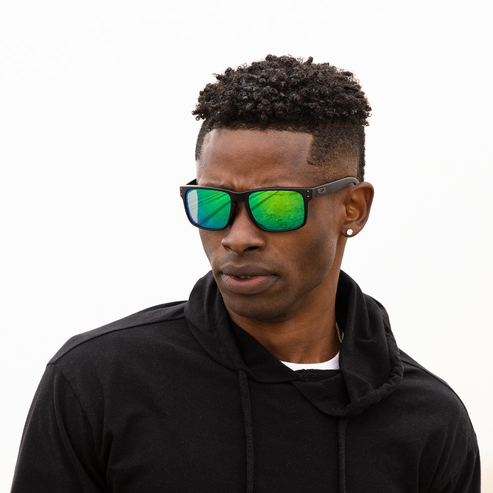 A person wearing sunglasses with Polarized Emerald Green lenses installed in the frame